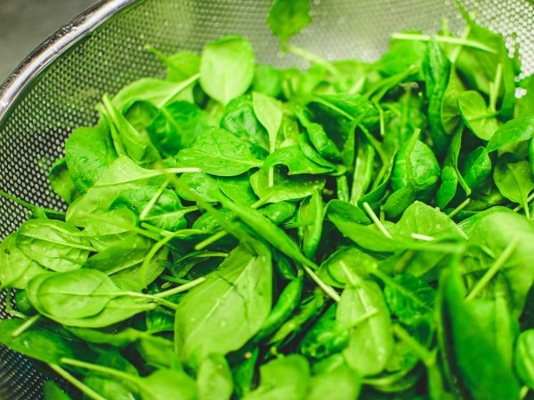 baby spinach in a colander