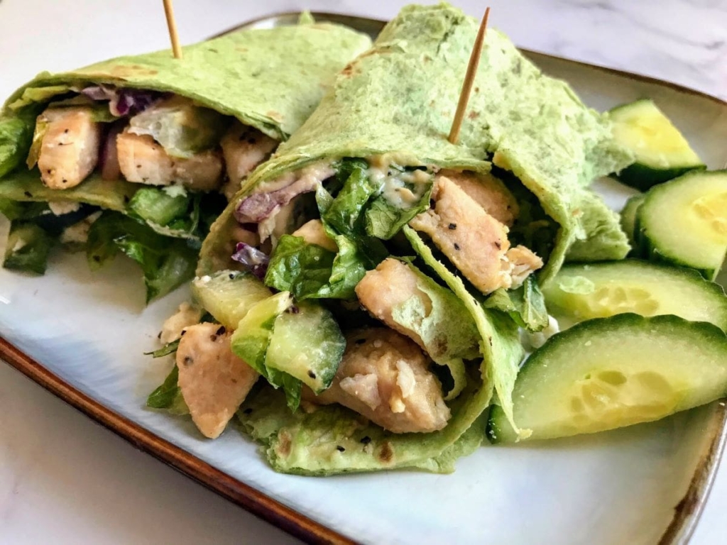 Mediterranean wrap on a plate with cucumbers